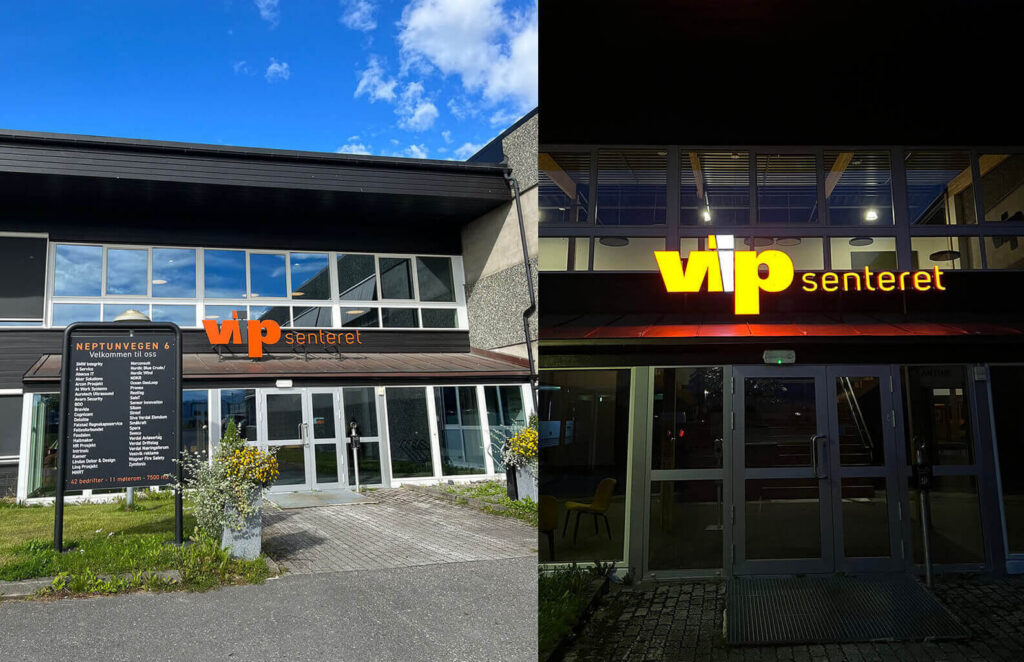 Fasadeskilt med lys for VIP Senteret på dagtid og kveld.